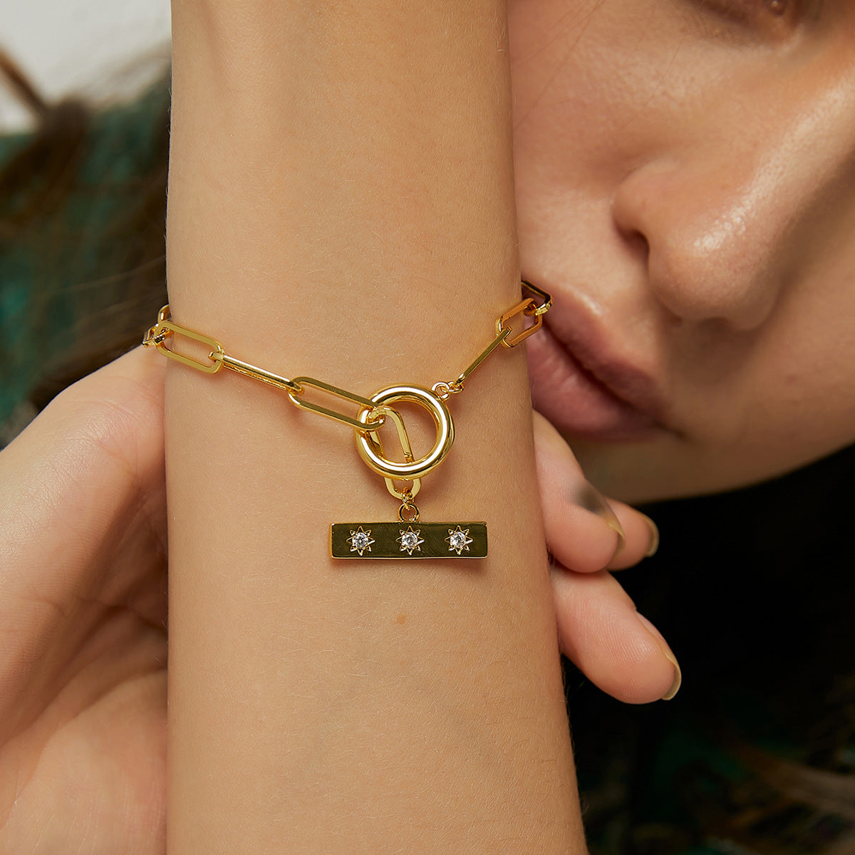 model wearing the paperclip-style link and toggle bracelet