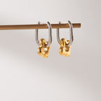 Two-Tone Floral Charm Stainless Steel Huggie Earrings — paired earrings on a neutral surface