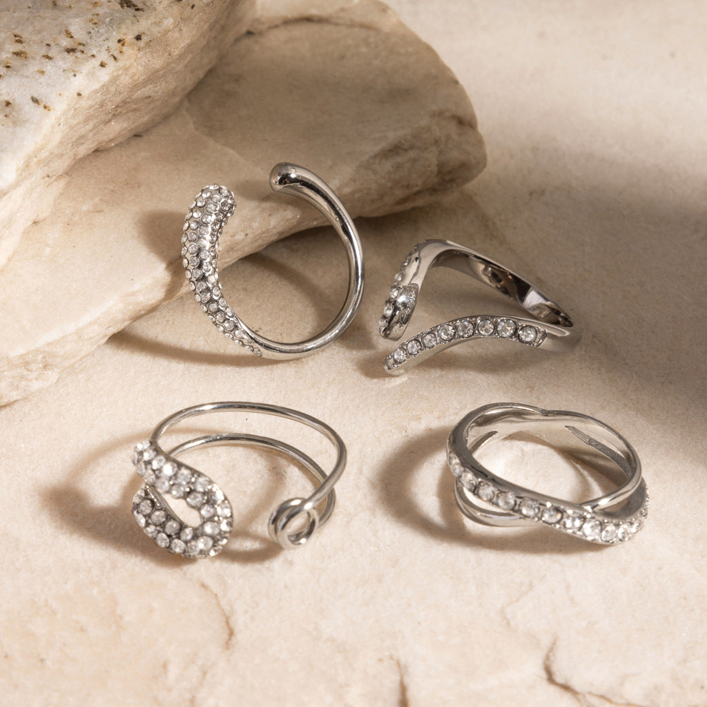 Four silver-tone stainless steel ring styles