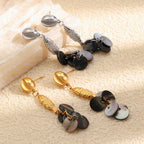 Gold and steel color fish earrings with dark shell discs