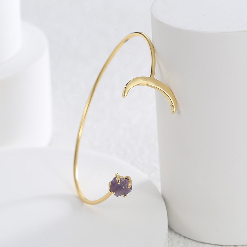 side profile of slender open cuff with crescent and stone ends