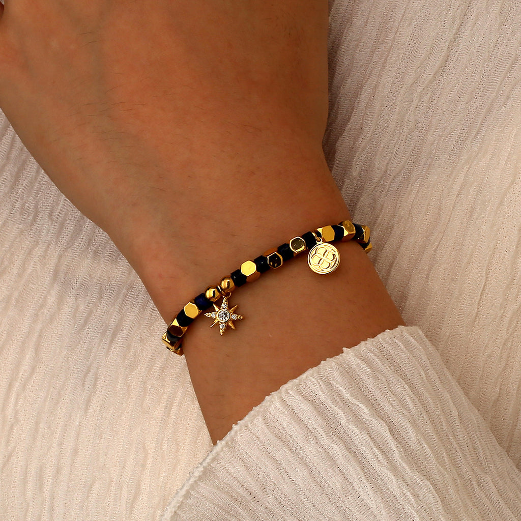 model wearing the starburst and coin beaded charm bracelet