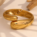 gold plated stainless steel twin snake-head hinged bangle in styled close-up