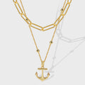 gold plated layered necklace with paperclip chain and anchor pendant