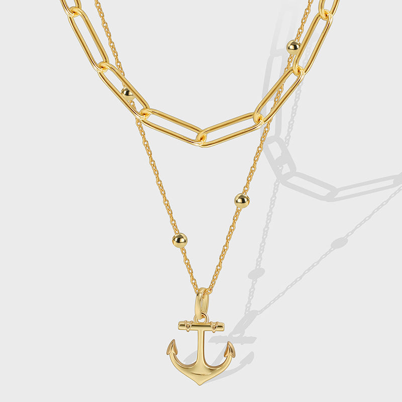 gold plated layered necklace with paperclip chain and anchor pendant