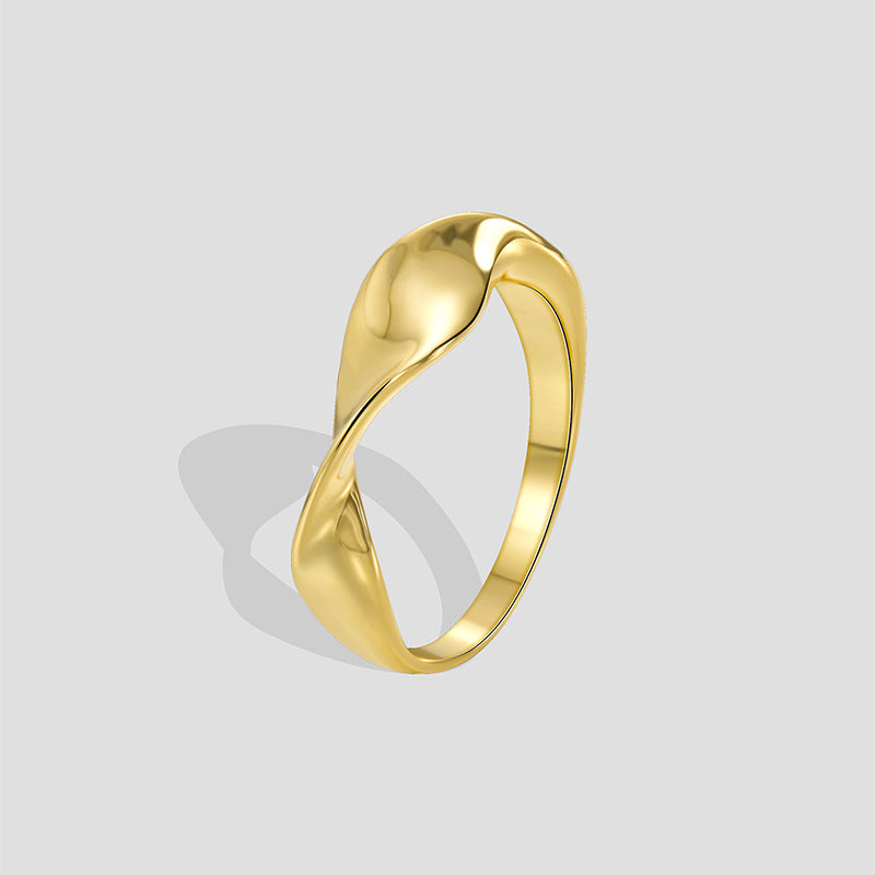 gold plated brass sculptural twist band ring on gray