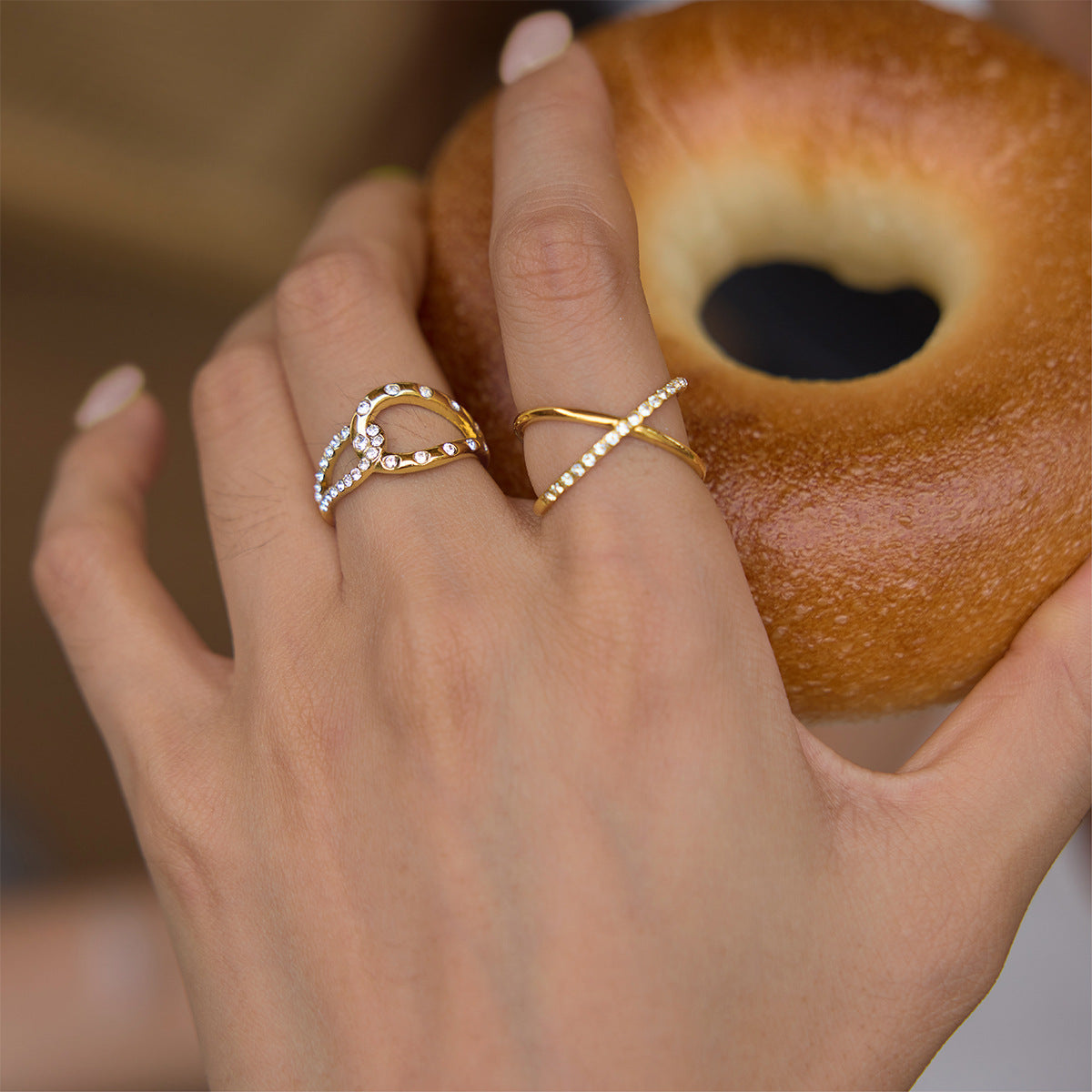 Two fine-line rings worn on fingers