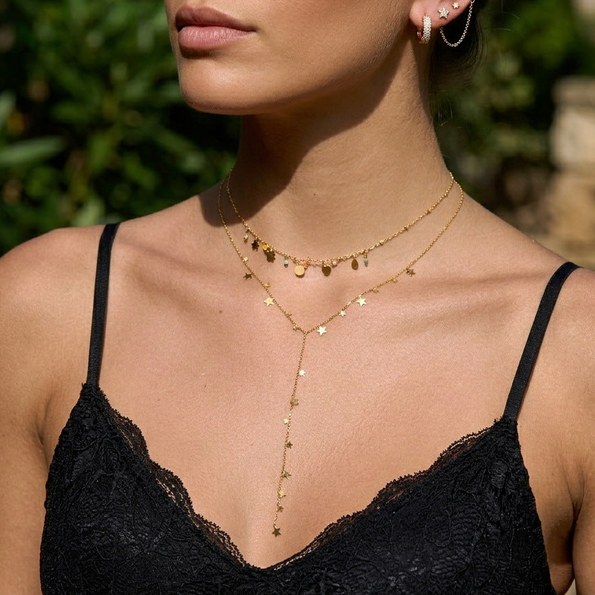 Star Y-necklace layered with a separate charm necklace