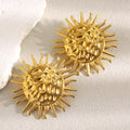 gold plated hammered sunburst statement stud earrings on a neutral surface