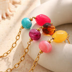 Close-up of contrasting resin bead pairs and gold tone links