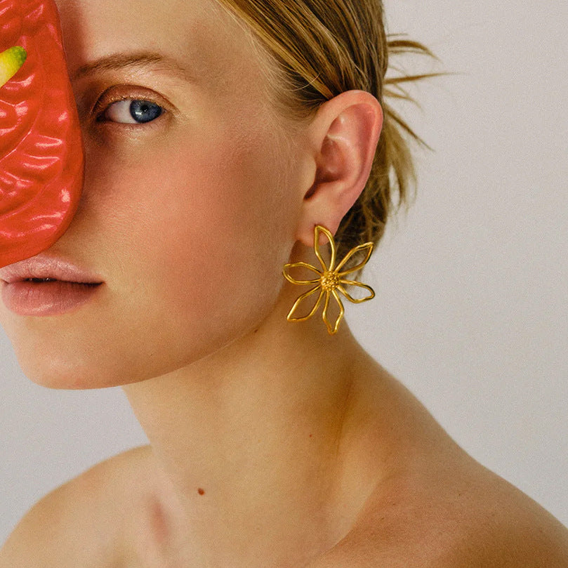 Gold-Tone Clear Accent Floral Stainless Steel Stud Earrings shown on model