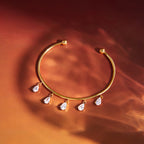 gold plated cuff bracelet with five clear-stone drops