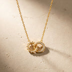 Interlocking sunburst and clear stone circle pendant on a fine chain