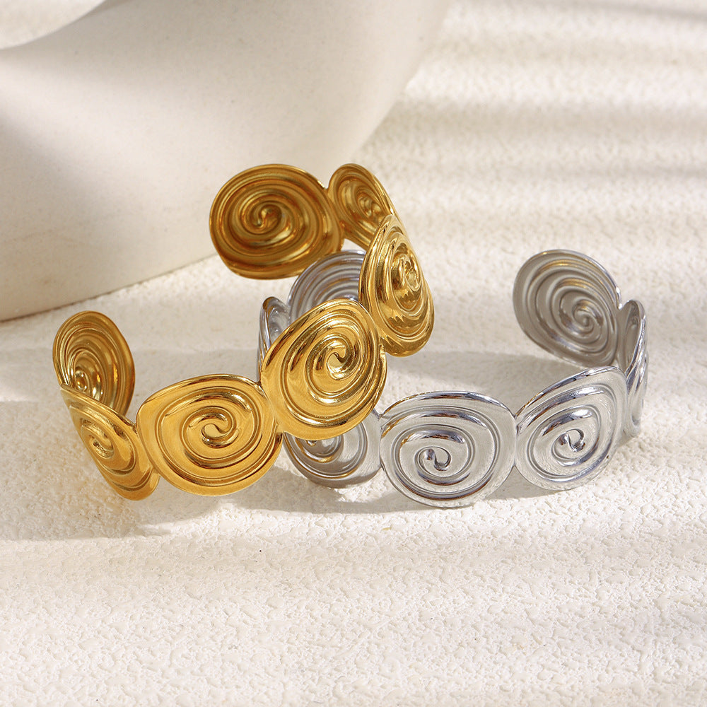 Gold plated and silver-color stainless steel cuffs with connected spiral discs