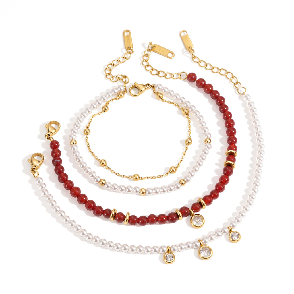 Red and white beaded stainless steel bracelets on white