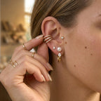Glass pearl and clear teardrop hoop styled with other ear jewelry
