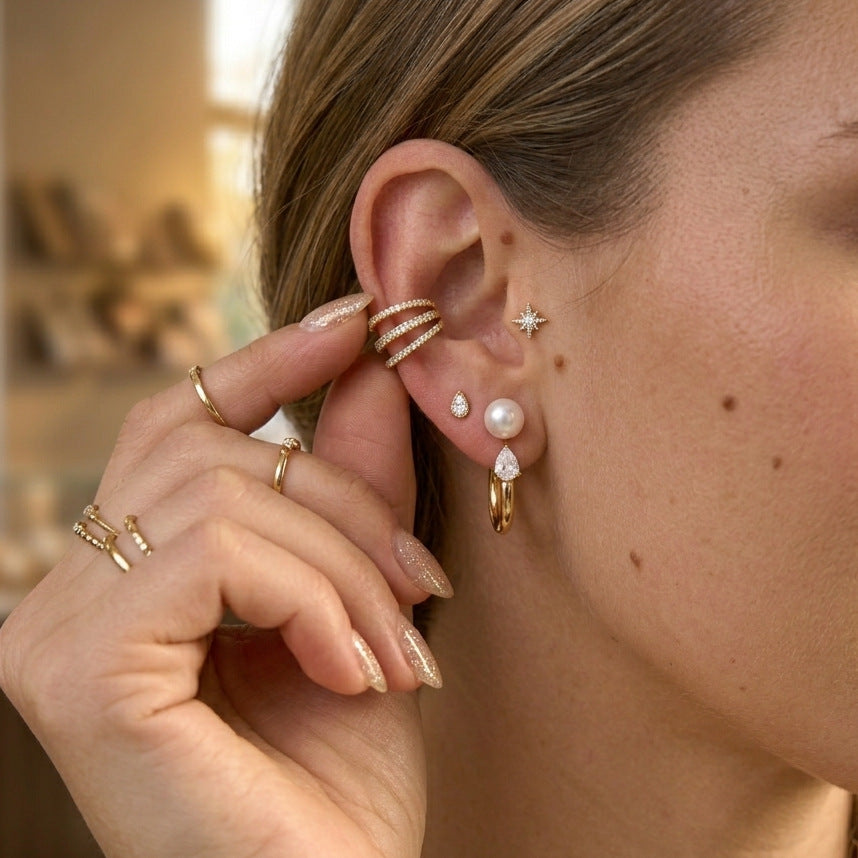 Glass pearl and clear teardrop hoop styled with other ear jewelry