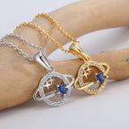 close view of ringed planet pendants with blue and clear faceted stones