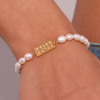 Freshwater pearl and 11:11 bracelet worn on a wrist