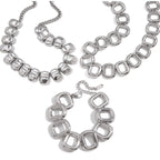 Two statement necklaces and bracelet on white