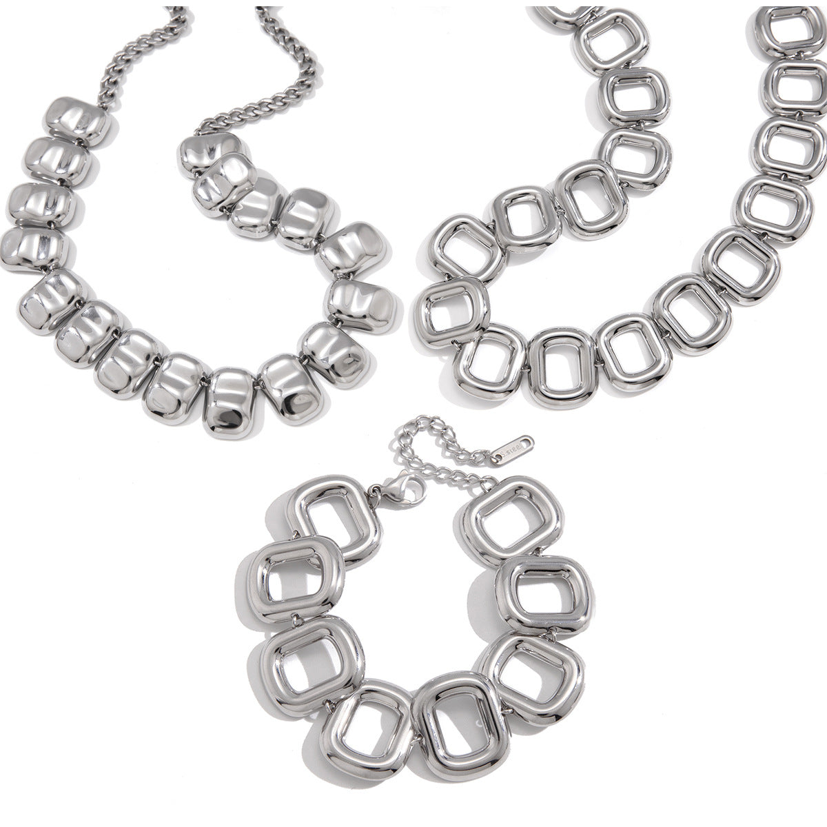 Two statement necklaces and bracelet on white