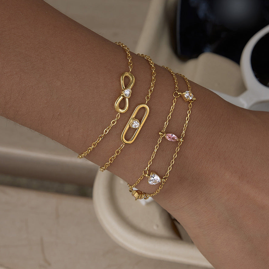 Gold-tone motif bracelets worn beside a cup