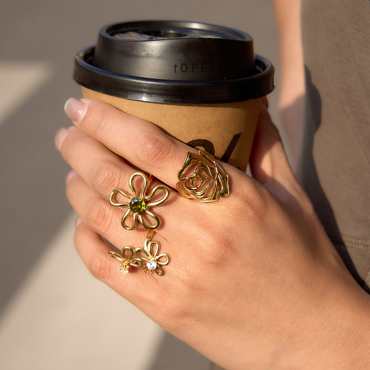 Sculptural rose stainless steel rings styled on a hand