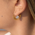 gold plated half-moon clear-stone hoop earring worn on ear