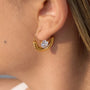 gold plated half-moon clear-stone hoop earring worn on ear