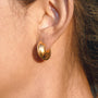 gold plated chunky C-hoop earring worn on ear