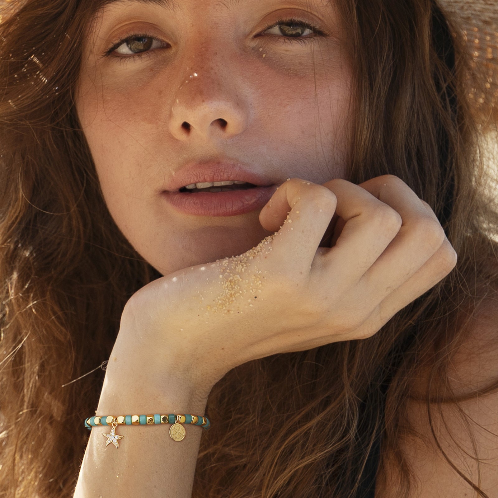 model wearing the aqua cube-bead starfish bracelet