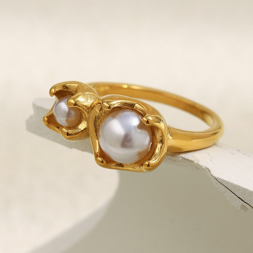 side view of graduated imitation pearls in sculpted bud settings
