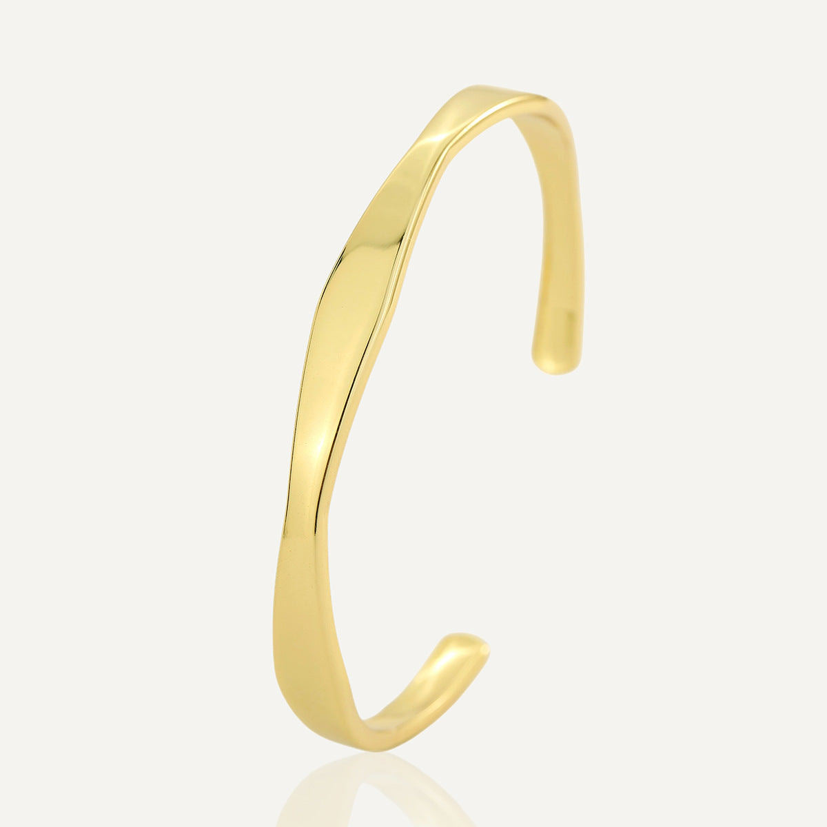 isolated gold plated brass Möbius twist open cuff bracelet