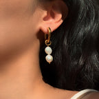 Gold-tone hoop with two freshwater pearls worn on an ear