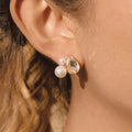 gold plated pear-cut and pearlized cluster stud earring worn on ear