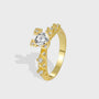 isolated gold plated geometric ring with clear zirconia center