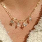 Clear accent MAMA letter necklace worn at the collar