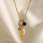 Gold plated fish charm necklace styled close-up