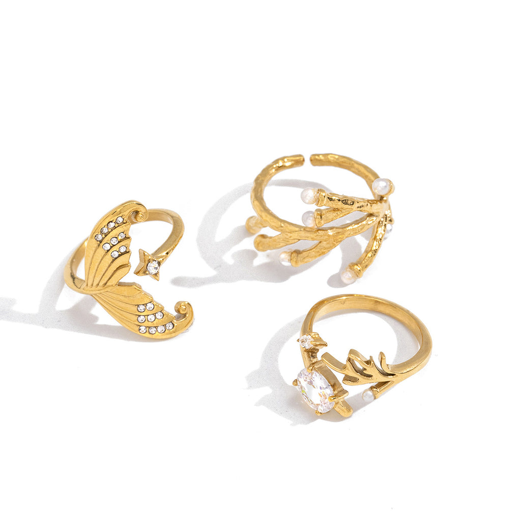 Coral and mermaid-tail rings on white