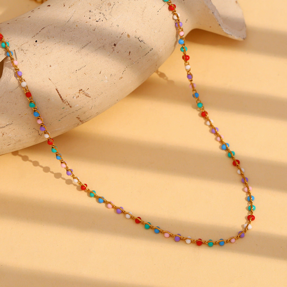Multicolor bead necklace arranged on a textured display