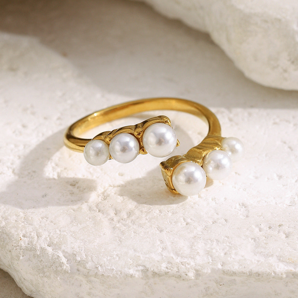 front view of paired three-pearl clusters on open ring