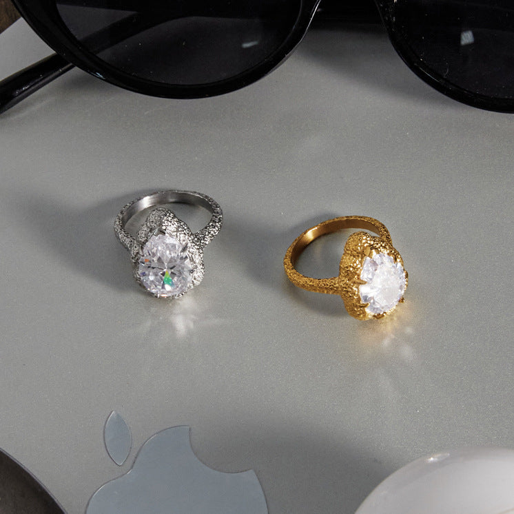 Both textured ring finishes beside sunglasses