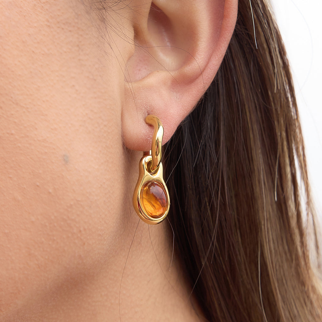 side view of amber-color resin cabochon hoop earring