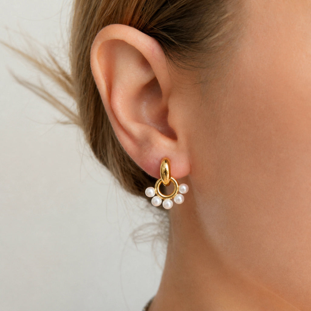 Resin pearl doorknocker earring worn close-up