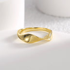 angled view of smooth folded gold plated twist ring