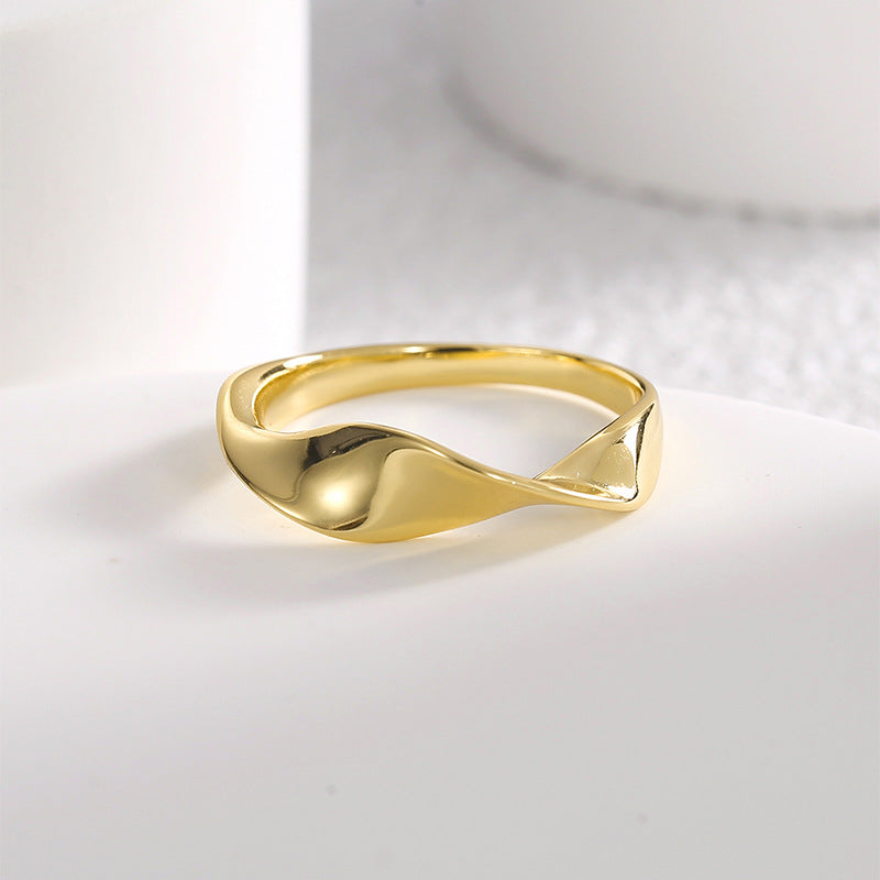 angled view of smooth folded gold plated twist ring