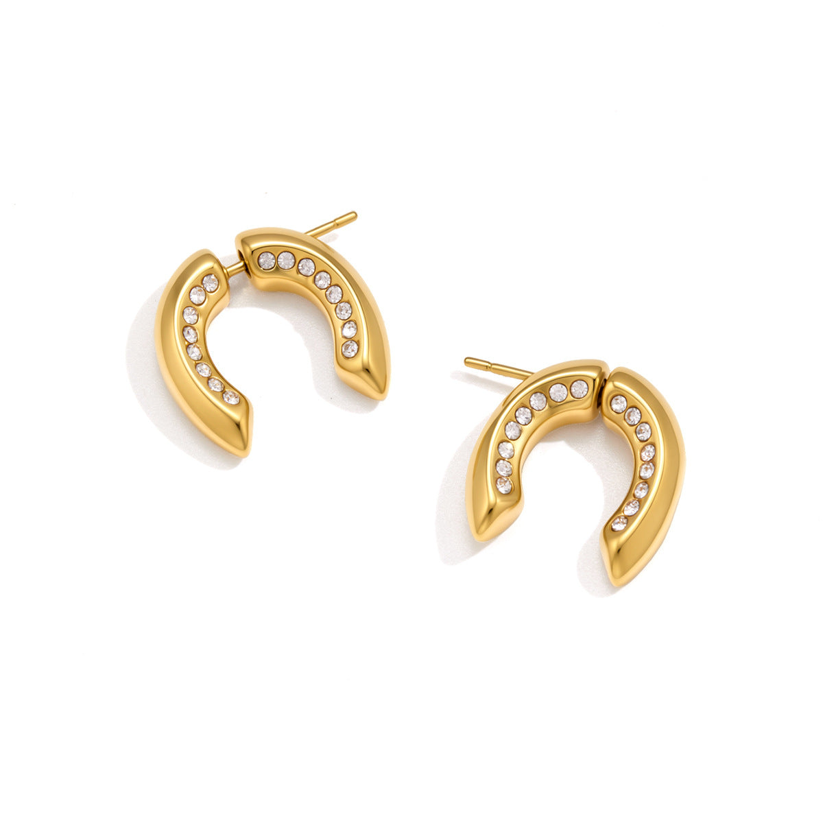 Pair of curved U earrings on white background