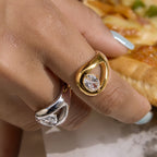 Gold-tone pear stone ring on a finger