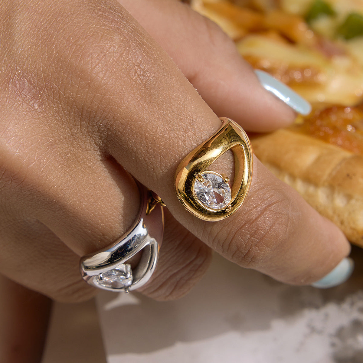 Gold-tone pear stone ring on a finger