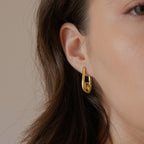 Gold-tone spiral hoop shown in profile
